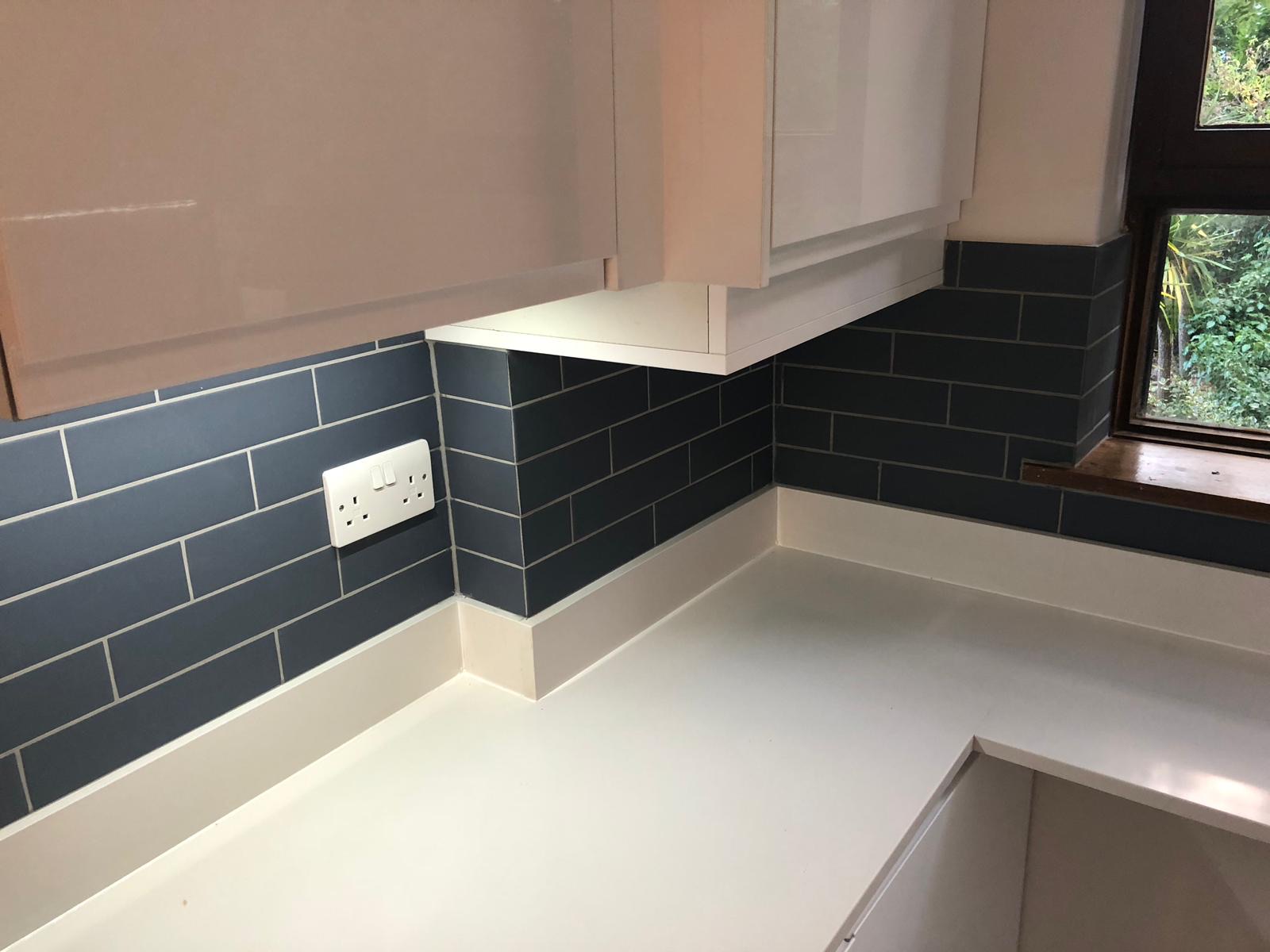 Kitchen corner with blue tile splashback